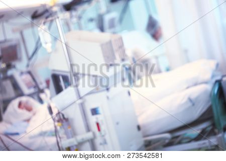 Cabinet In The Hospital With Equipment And Patient. Blurred Unrecognizable Background