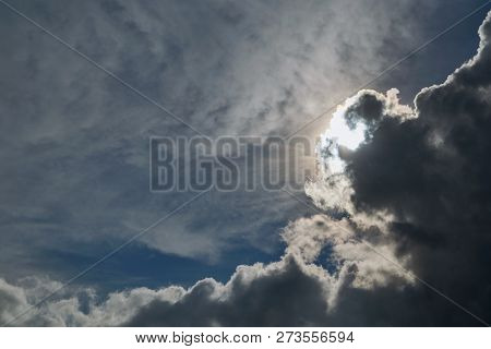 The Sun Shines Brightly In The Clear Blue Sky. Big Storm Clouds Are Coming. Cumulus Clouds Before Ra