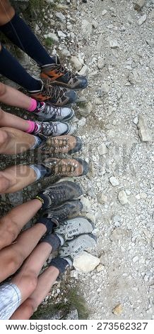 5 Pairs Of Feet Of A Family That Rests After A Long Walk In The Mountains