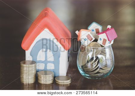 Mini House On Stack Of Coins,money And House,  Mortgage, Savings Money For Buy House And Loan To Bus