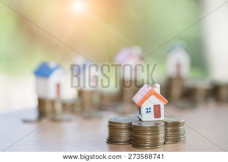Mini House On Stack Of Coins,money And House,  Mortgage, Savings Money For Buy House And Loan To Bus