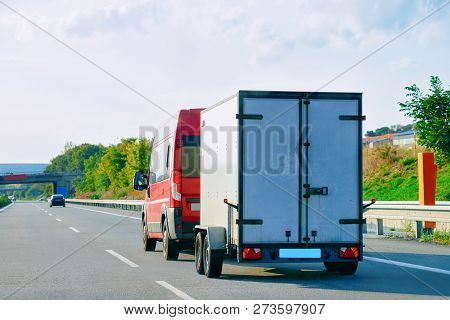 Mini Van Carrying Trailer At The Asphalt Road In Slovenia.