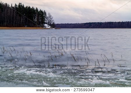First Ice On The Lake In Late Autumn. Winter Coming Landscape