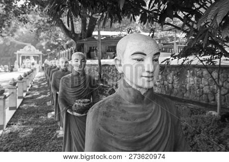 Hpa-an, Myanmar - 19 November, 2018: Black And White Picture Of Many Aligned Monks Statues At Kaw Ka