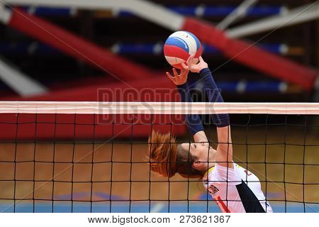 KAPOSVAR, HUNGARY â DECEMBER 2, 2018: Kristina Cesljar (in white) in action at a Hungarian National Championship volleyball game between Kaposvar (white) and Palota VSN (blue) in Sportcsarnok Kaposvar