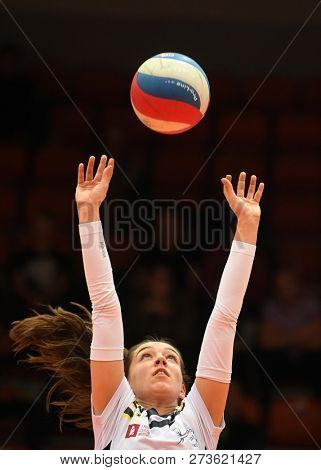 KAPOSVAR, HUNGARY â DECEMBER 2, 2018: Viktoria Kalmar posts ball at a Hungarian National Championship volleyball game between Kaposvar (white) and Palota VSN (blue) in Sportcsarnok Kaposvar.