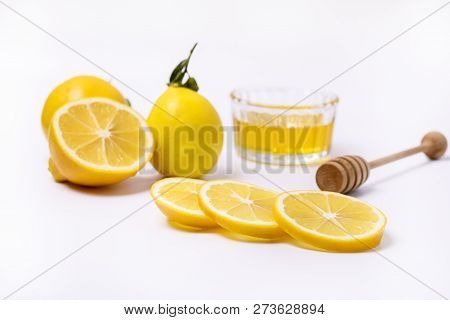 Slace Of Fresh Ripe Lemon And Wooden Honey Dipper On White Background Honey Horizontal