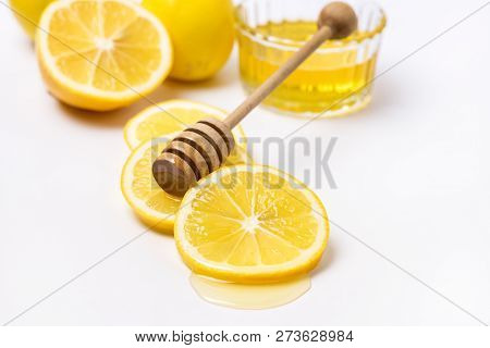 Slace Of Fresh Ripe Lemon And Wooden Honey Dipper On White Background Honey Horizontal