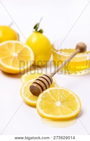 Slace Of Fresh Ripe Lemon And Wooden Honey Dipper On White Background Honey Vertical