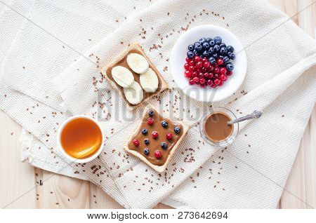 Fletley From Healthy And Wholesome Food. Namely, This Is Peanut Paste, Toast, Fruit, Sesame, Berries