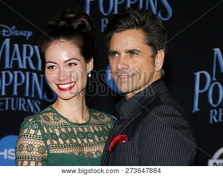 Caitlin Mchugh and John Stamos at the World premiere of Disney's 'Mary Poppins Returns' held at the Dolby Theatre in Hollywood, USA on November 29, 2018.