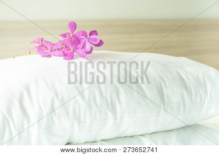 Pillows And Beautiful Orchid Flower On Top In The Bed Room.