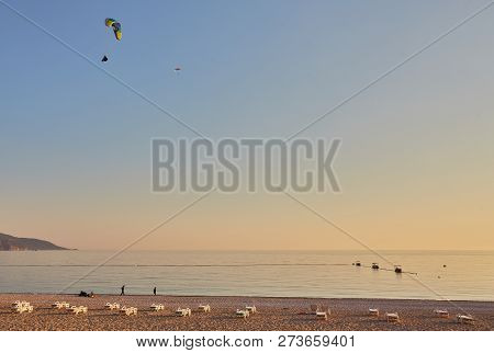 Paraglider Silhouette Flying Over Misty Mountain Valley In Beautiful Warm Sunset Colors - Sport, Act