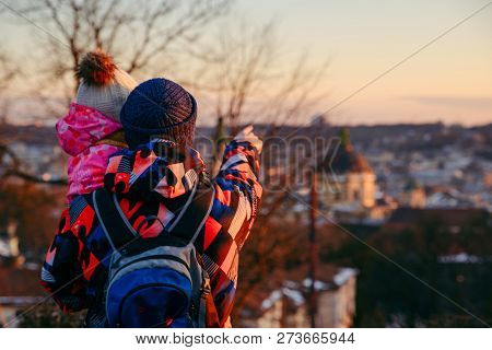 Father With Little Daughter Looking At Old European City At Sunset. Travel Lifestyle