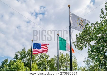 Flags Of United States, Irland And Rhode Island State Fluttering Against A Blue Sky, Near Rhode Isla