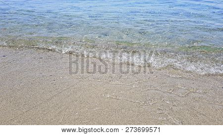 The Blue Sea Washes The Sandy Shore