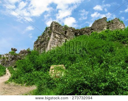 Remains Of Khust Fortress - Bottom View. The Ruins Of An Ancient Stone Castle Are Covered With Grass