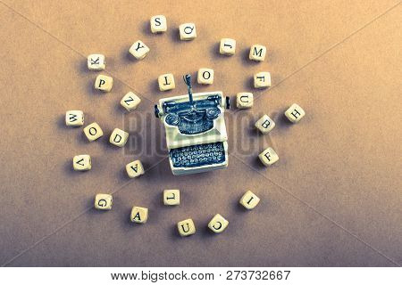 Letter Cubes Of Made Of Wood Around Model Typewritter