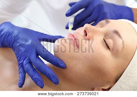 Enlarging Lips. 
A Patient In A Cosmetic Clinic, A Beautician Performs An Injection Procedure.