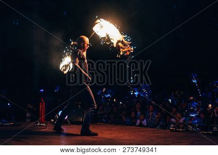 Vichuga, Russia - June 17, 2018: Fire Show, A Man Fakir Waving Burning Torches