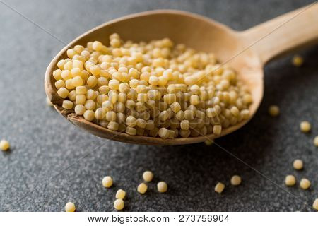 Raw Dry Organic Couscous In Wooden Spoon / Turkish Kuskus