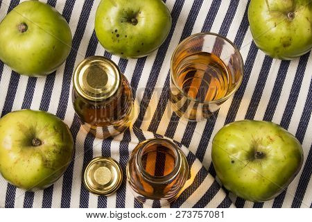 Home Made Apple Juice From An Old British Apple Variety, Bramley In A Glass And Bottle