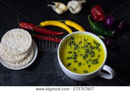 Pumpkin Asian Coconat Cream Soup. Autumn Hot Food. Chili Pepper, Garlic, Red Onion, Big Pumpkin. Dar