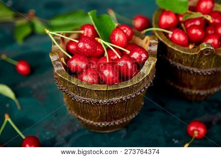 Red Cherry In Bowl On Green Background. Summer Or Spring Concept.