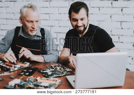 Two Men Repairing Hardware Equipment From Pc. Repair Shop. Worker With Tools. Computer Hardware. You