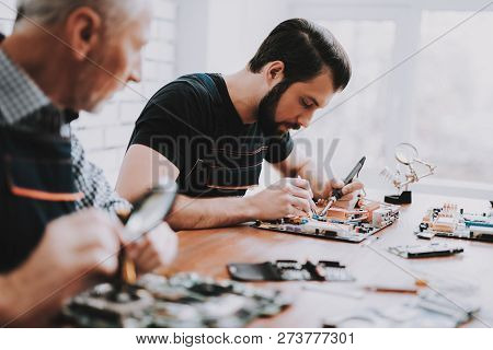 Two Men Repairing Hardware Equipment From Pc. Repair Shop. Worker With Tools. Computer Hardware. You