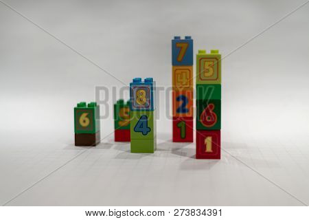 Stacked Plastic Multicolor Blocks With Number In Them.