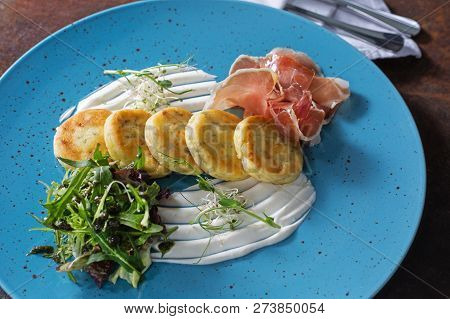 Potato Pancakes With Bacon With Green On Blue Background