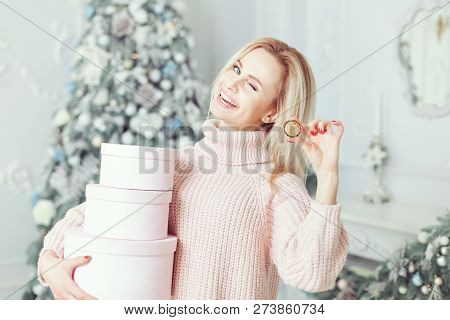 Woman Smiles And Winks, There Is A Bitcoin Coin In Her Hand.