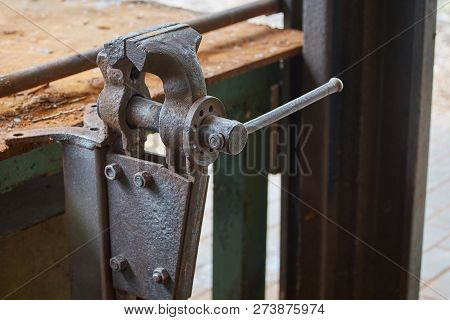 Old Rusty Vise On Iron Table In Workshop
