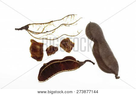 View Of A Whole Tamarind Fruit And The Pulp, Seeds And Fibers Of A Broken Tamarind (tamarindus Indic