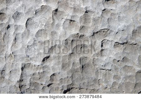 Pale Rock Rough Texture. Stone Surface Photo. Chipped Stone Surface With Cutter Marks. Aged Stone Wa