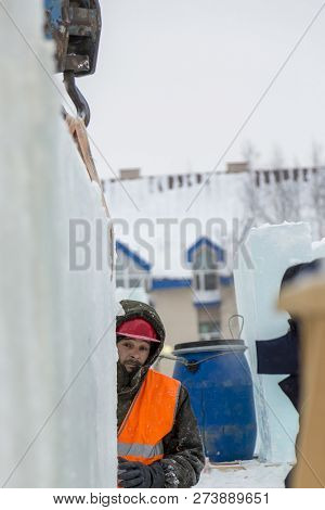 Worker Fitter In A Protective Helmet And Reflective Vest On The Working Meast