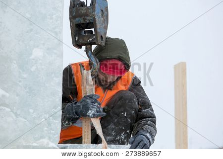 Worker Fitter In A Protective Helmet And Reflective Vest On The Working Meast