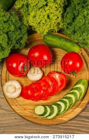 Fresh Vegetables. Tomatoes, Cucumbers And Mushrooms On A Wooden Board