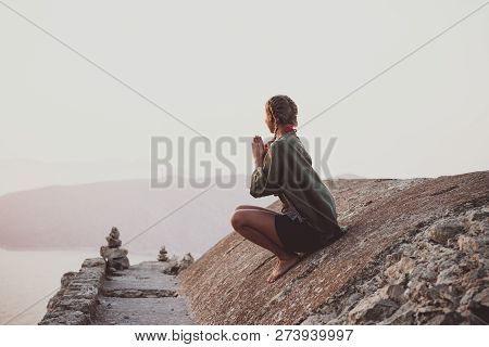 Woman Sitting And Meditating On Stones In Monolithos, Rhodes, Greece