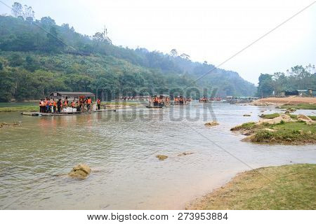 Cao Bang, Vietnam - Nov 30, 2018 : Tourist Visiting Ban Gioc Waterfall Or Detian Falls By Bamboo Boa