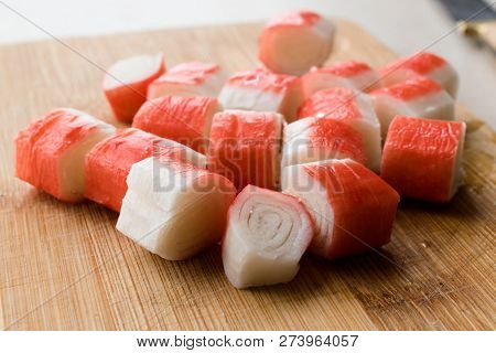 Fresh Sliced Crab Stick Slices Surimi On Wooden Board. Ready To Eat.