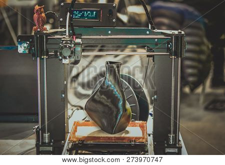 3d Printer Printing A Model In The Form Of Black Vase Close-up.