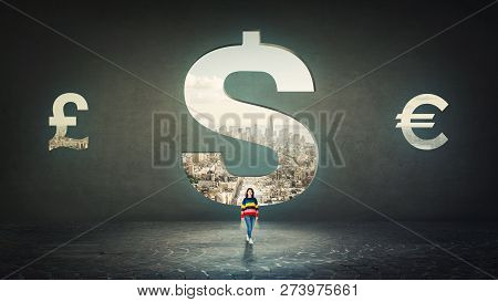 Confident Woman Standing Alone In Front Of A Dollar Sign Hole As A Door Shaped In A Concrete Wall Wi