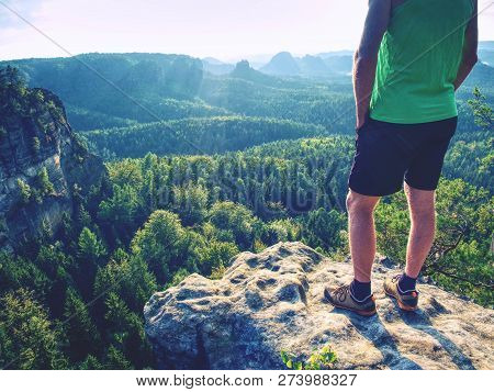 Green Singlet And Black Pants Fearless Boy In Rocks. Amazing View Into Wild Nature Landscape.