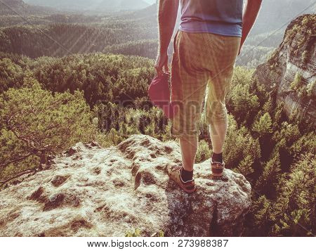 Hiker Man Stays On The Mountain Hill During Hiking. Hker Staying On Rock And Looking Down To Valley