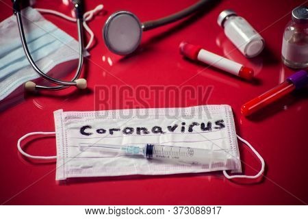 Mask With Word-coronavirus, Medicine Items On Red Background. Medine And Healthcare Concept