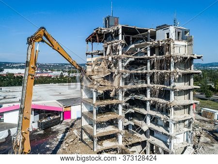 Aerial View Of Building House Demolition And Construction Site Excavator With Hydraulic Crasher Mach