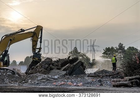 Dawn Time Building House Demolition Site Excavator With Hydraulic Crasher Machine And Yellow Contain