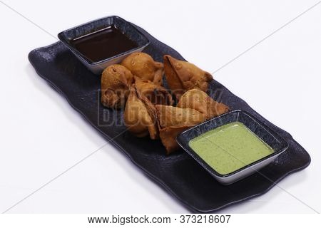 Indian Snack Samosa Plater With Mint And Tamarind Sauce
